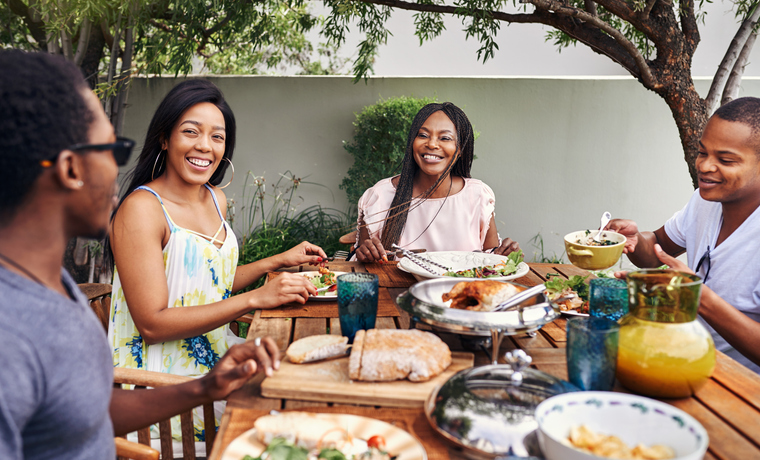 Happy family enjoying an excellent dinner. MenuCoverMan.com