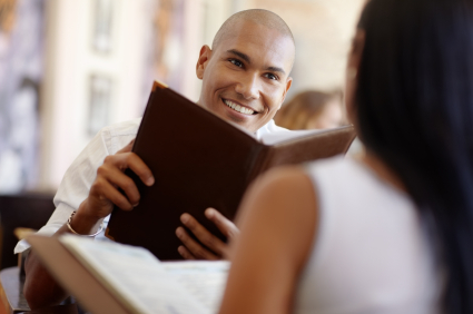 Couple on a date holding menucoverman menu covers.