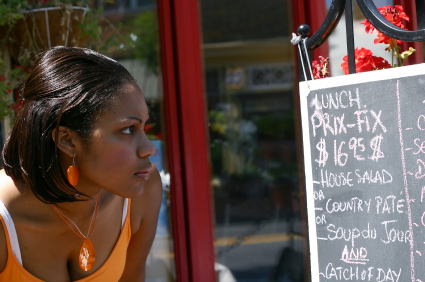 woman studying sidewalk menu