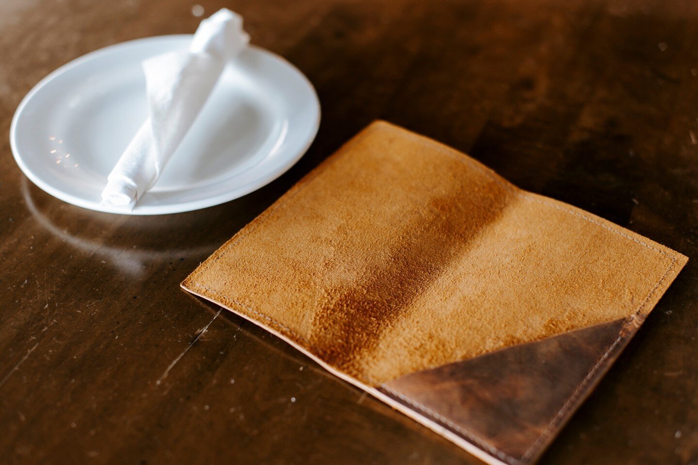 Leather menu cover on the dining room table.